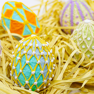 Group of decorated eggs in a 3D pen art pile.