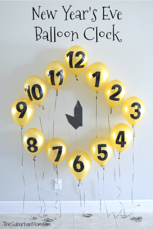 fun clock made with golden balloon and black numbers