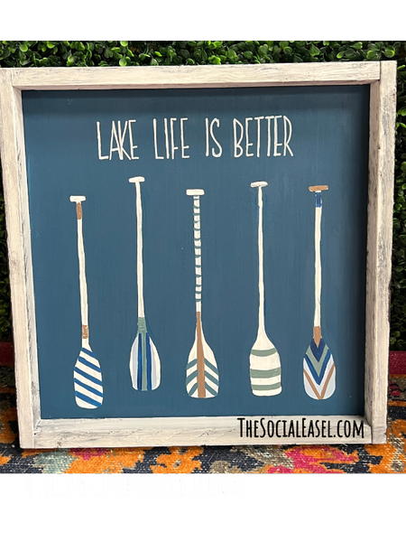 Lake Life Is Better painted on canvas. Dark navy background with 5 oars all painted with different designs. 