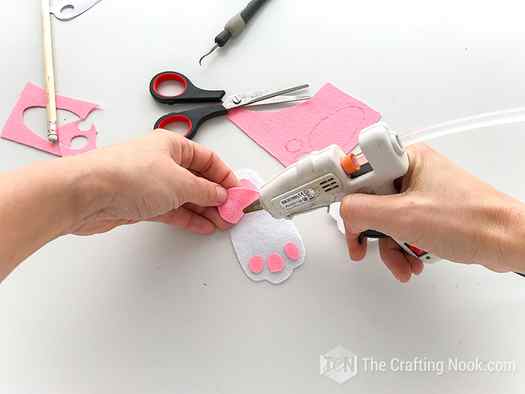 Gluing pink pieces on the white pieces