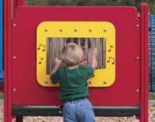 Child plays with chime panel at playground