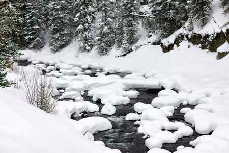 Winter snow pillows on Soda Butte Creek in Yellowstone National Park, Wyoming