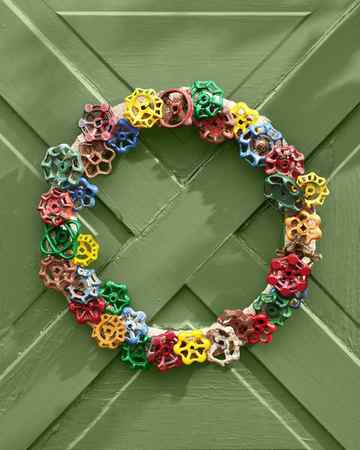 wreath made from vintage faucet handles hung on a green door
