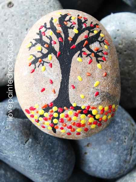 What a cool fall rock painting idea. Using 3D paint makes it easy to make the leaves on this beautiful tree painted rock. #ilovepaintedrocks #rockpainting #PaintedRockIdeas #paintedrocks #paintrock #kindnessrocks #paintedstone #rockart #stoneart #paintedstoneideas #crafts #rockcrafts #fall #fallcraft #fallpainting