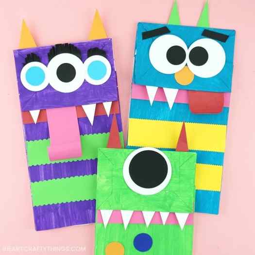 Three paper bags are transformed into brightly colored monsters.