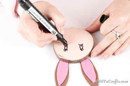 Drawing on eyes for wood slice Easter bunny