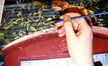 Artist working on ginger cat painting