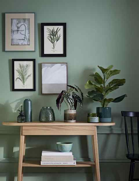 stylish room with green paint and wooden sideboard