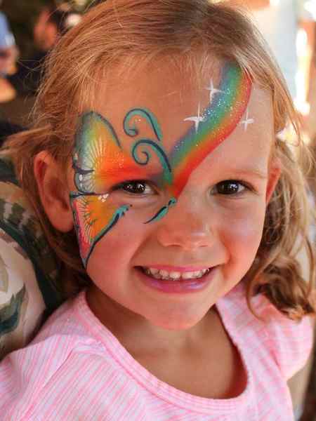 Rainbow butterfly face paint by Auntie Stacey