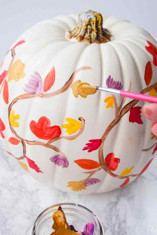 painted white pumpkin with fall leaves