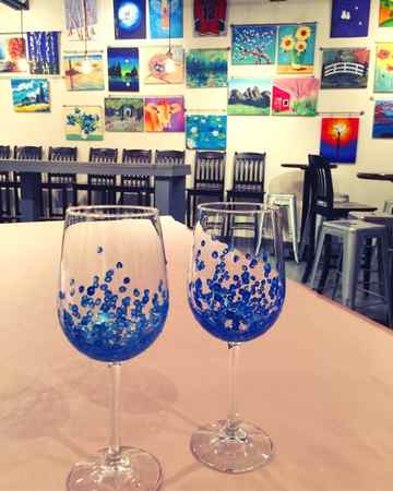 Painted wine glasses on table.