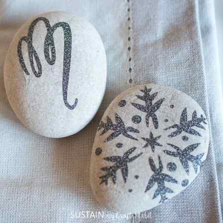 use your cricut maker to make these snowflake, monogrammed painted rock craft