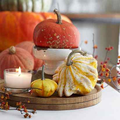 Fall centerpiece with candle and miniature pumpkins