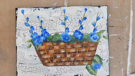 blue flower painting in a basket in acrylics on a crackled background of cream color