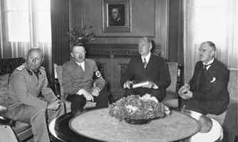 The flowers at the center of this photograph of Mussolini, Hitler and Chamberlain, taken at the 1938 Munich conference, caught Simon’s eye.