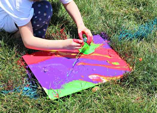 Image shows a kid making a painting with balloons on grass. Idea from Living a sunshine life
