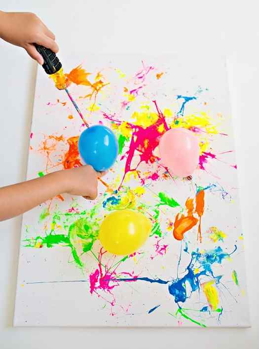 Image shows messy art created with balloon splatter paint. Idea from Hello Wonderful