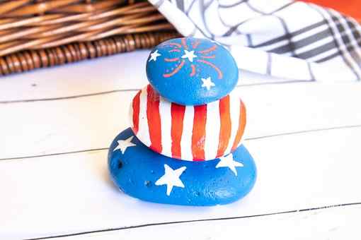 patriotic painted rocks stacked on top of eachother