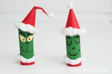 Grinch crafts- 2 toilet paper rolls painted green and red with grinch faces on them