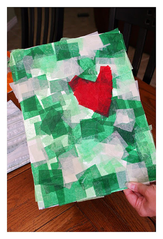 Grinch craft- green and white and red tissue paper craft showing the grinch