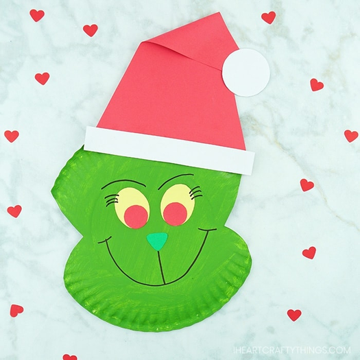 Grinch crafts- paper plate green and red grinch on white background with hearts