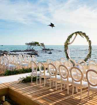 chairs and altar arranged for a beachfront wedding