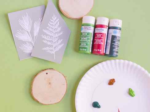 Supplies for DIY stenciled wood sliced ornaments
