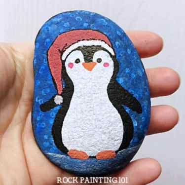 Learn how to draw a penguin for an adorable winter painted rock. Using a block painting process, you