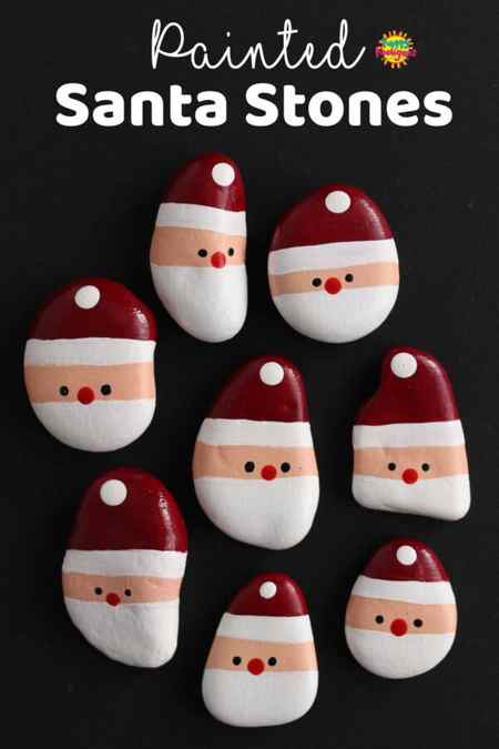 smooth stones painted to look like simple santa faces 