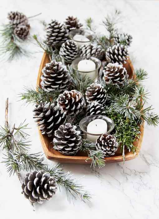 farmhouse table decorations with candles and DIY snow covered pine cones & branches in wood tray
