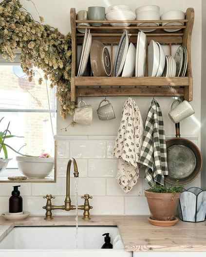charming country kitchen scene with a sink, window and a plate shelf