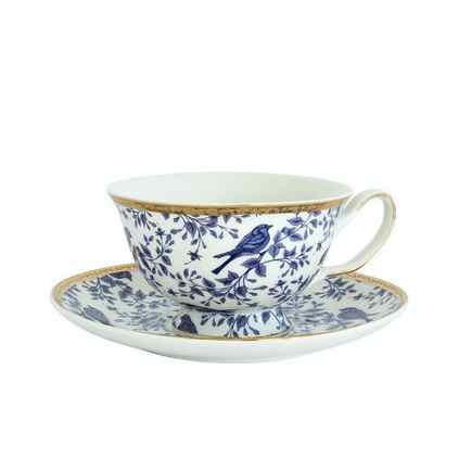 a blue and white floral tea cup with a gold rim