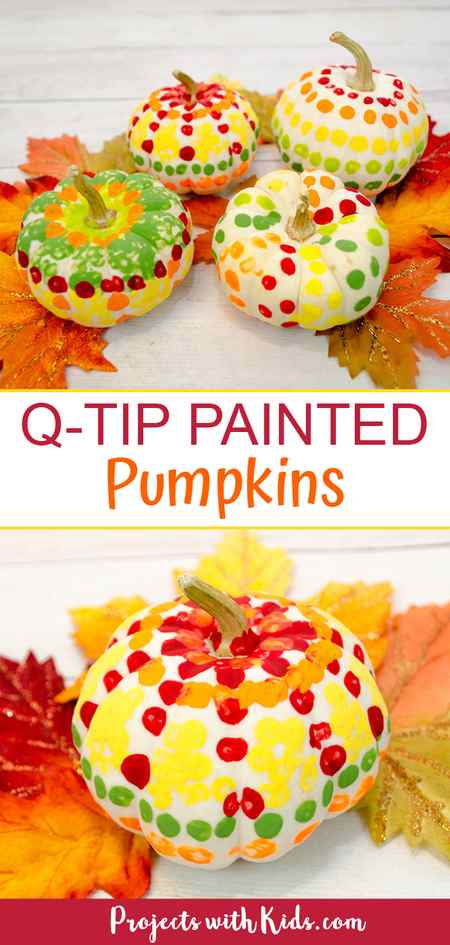 Q-tip painted pumpkins using mini white pumpkins placed on fall leaves