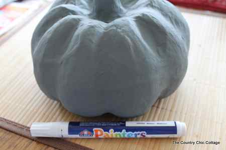 painting base paint color on what will be a faux bois pumpkin