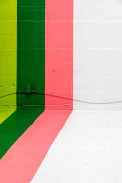 colorful pink and green painted stripes on wall