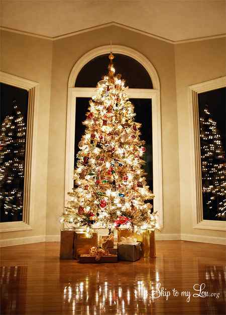 Decorated DIY gold Christmas Tree in front of three windows. -Skip To My Lou