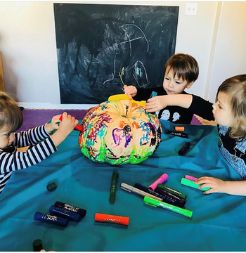 Children painting pumpkin with Kwik Stix Solid Tempera Paint 