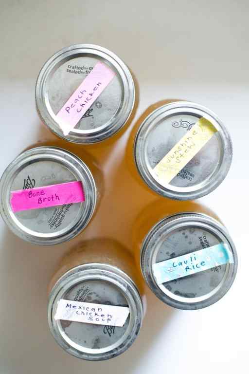 five mason jars with metal lids and taped labels with recipe names