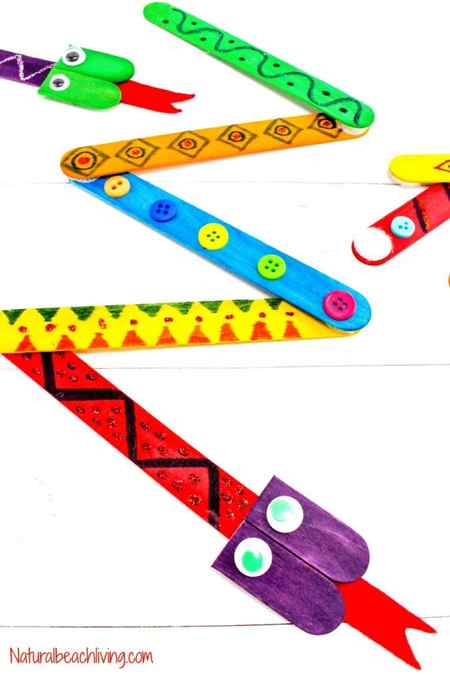 Easy crafts for kids use popsicle sticks like this one that uses colored popsicle sticks to form the bodies of snakes. Buttons and drawings are on each stick.
