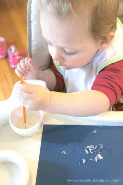 baby painting and learning with snow paint