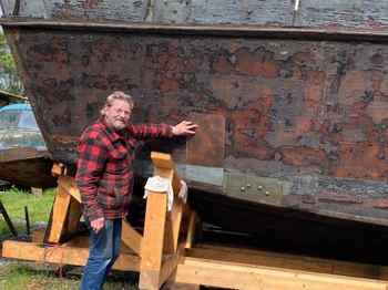 Eric Hollenbeck points out a hole patched on the Higgins boat that was preserved and restored after being pulled from Lake Shasta. (Blue Ox Millworks/Contributed)