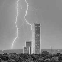 Lightning Surrounding CityPlex - Tulsa Oklahoma Black and White by Gregory Ballos
