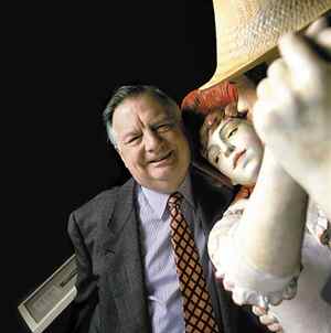 Seward Johnson posing next to a statue of a man and a woman dancing