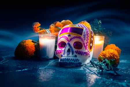 sugar skull decorated with purple icing and foil