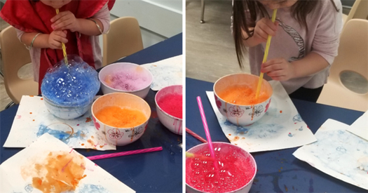 Two photos of a preschool aged child making bubbles using a straw and a bowl filled with soapy water and paint.