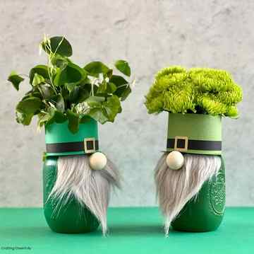 mason jars decorated like gnomes for a st patricks day craft with long beards, green top hats, filled with green flowers