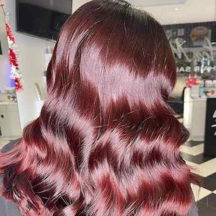 back of head reveals shiny plum brown hair styled in soft waves