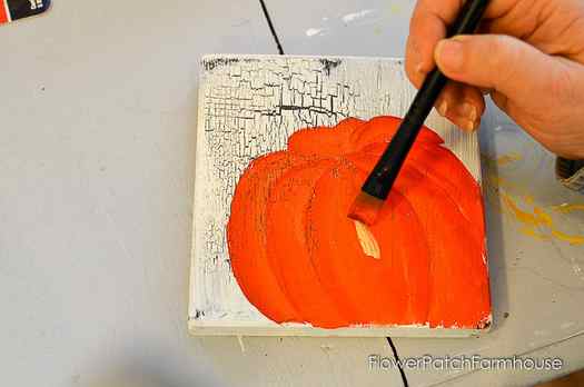 Adding highlights to orange pumpkin acrylic painting