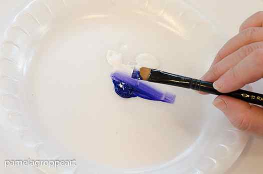 blue and white paint loaded on flat brush, pamela groppe art