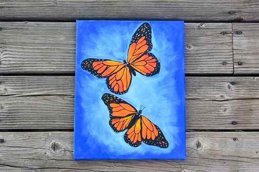 Monarch Butterfly painting, blue background with 2 butterflies